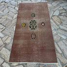 Pale Red 3' x 7' vintage Turkish distressed rug in wool and cotton, shown on the floor.