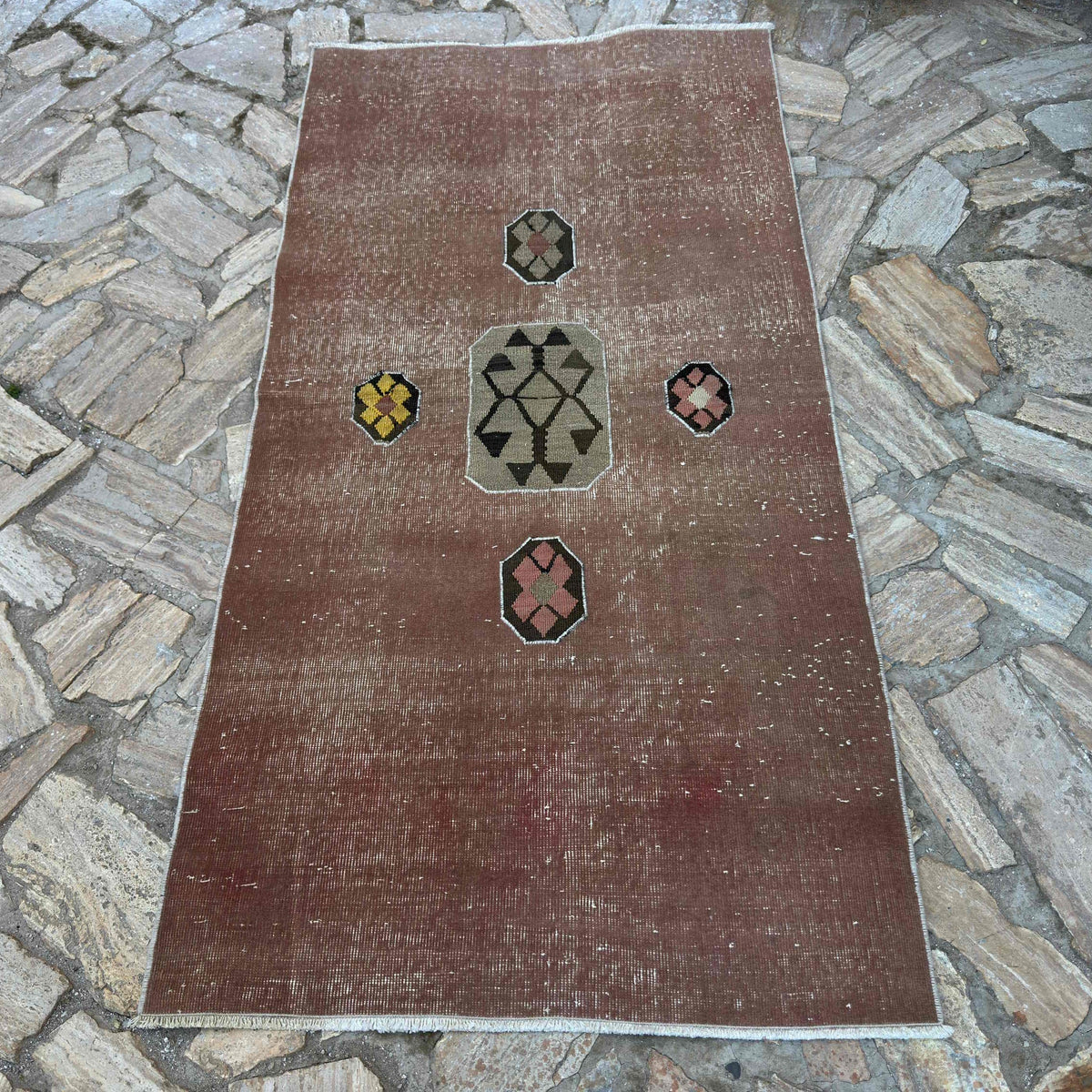 Pale Red 3' x 7' vintage Turkish distressed rug in wool and cotton, shown on the floor.