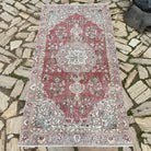 Red 3' x 7' vintage Turkish distressed rug in wool and cotton, shown on the floor.