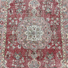 1970s red vintage Turkish distressed rug with medallion design, hand-knotted weave and low pile.