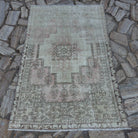 Pale Pink 4' x 6' vintage Turkish distressed rug in wool and cotton, shown on the floor.