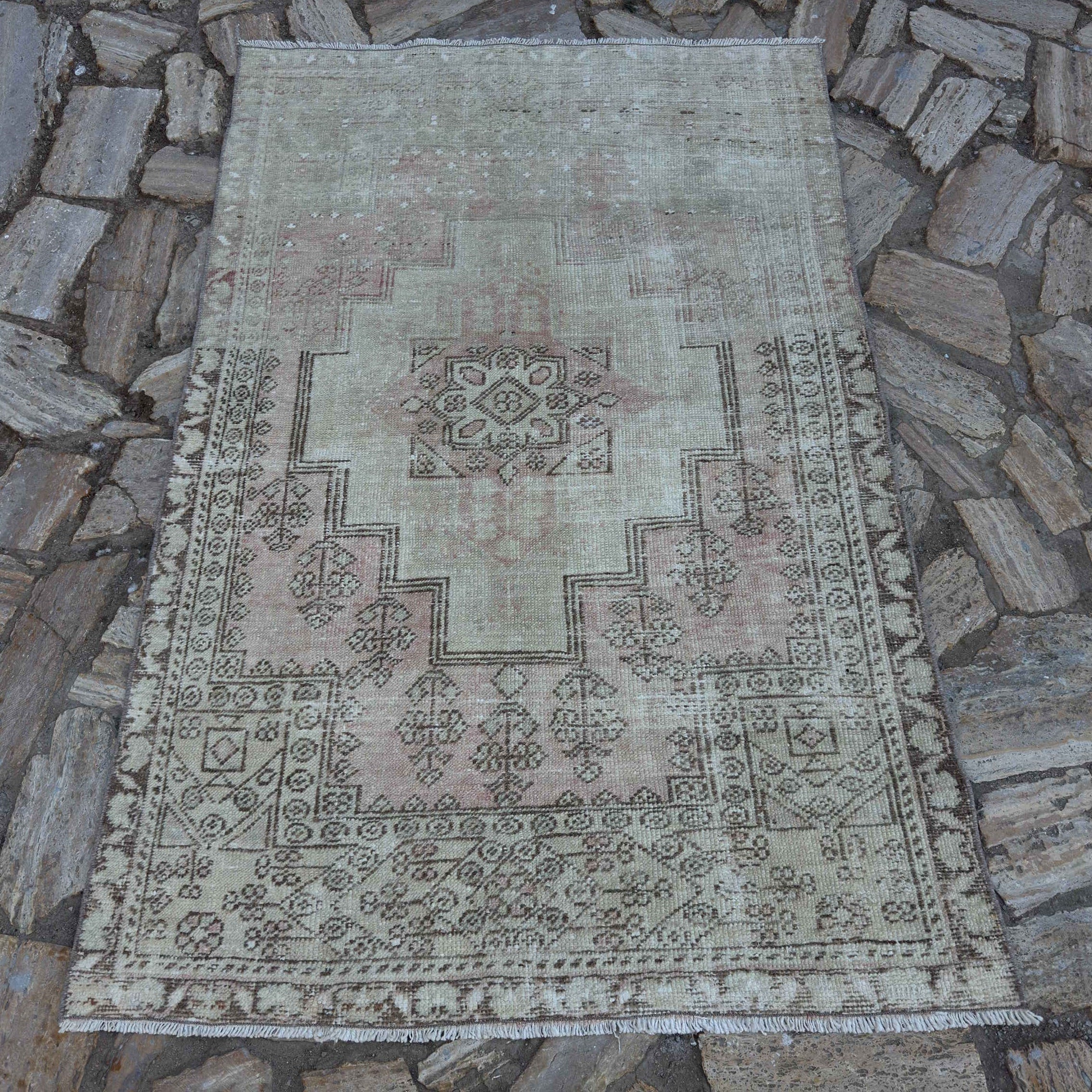 Pale Pink 4' x 6' vintage Turkish distressed rug in wool and cotton, shown on the floor.