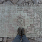 1970s pale pink vintage Turkish distressed rug with neutral design, hand-knotted weave and low pile.