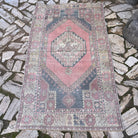 Pink 4' x 6' vintage Turkish distressed rug in wool and cotton, shown on the floor.