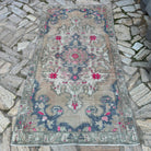 Beige 4' x 7' vintage Turkish distressed rug in wool and cotton, shown on the floor.