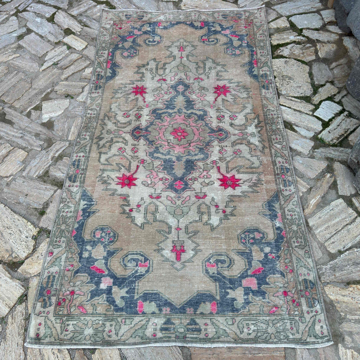 Beige 4' x 7' vintage Turkish distressed rug in wool and cotton, shown on the floor.