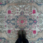 1970s beige vintage Turkish distressed rug with traditional design, hand-knotted weave and low pile.