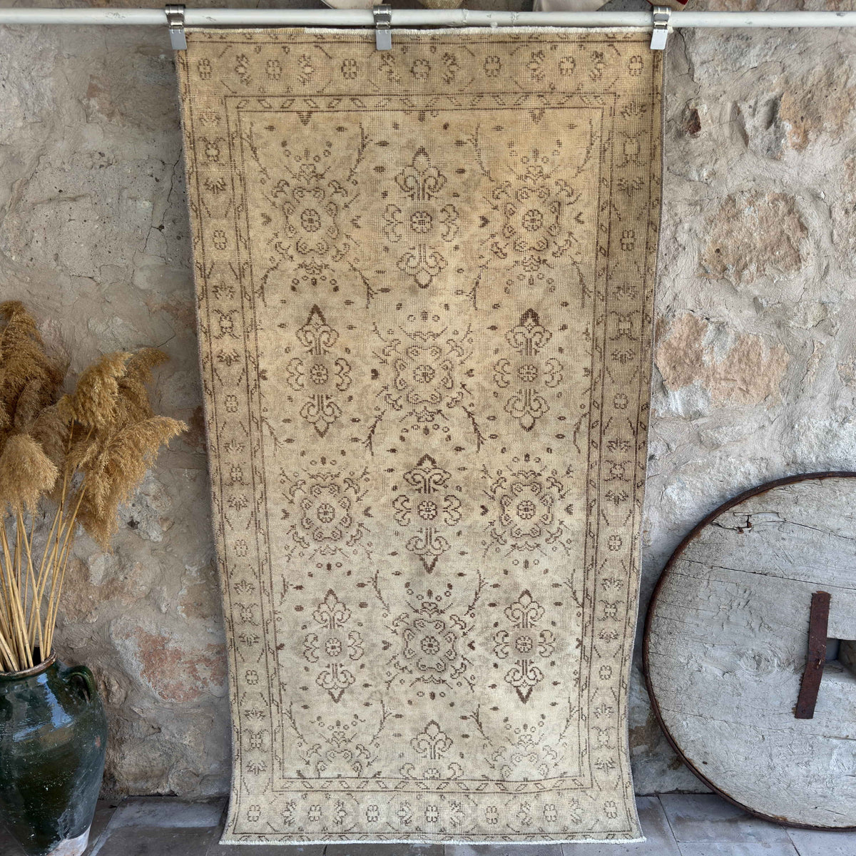 Beige 4' x 7' vintage distressed rug with floral design, handmade in Turkey – Kori.