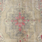 1970s beige vintage Turkish distressed rug with neutral design, hand-knotted weave and low pile.