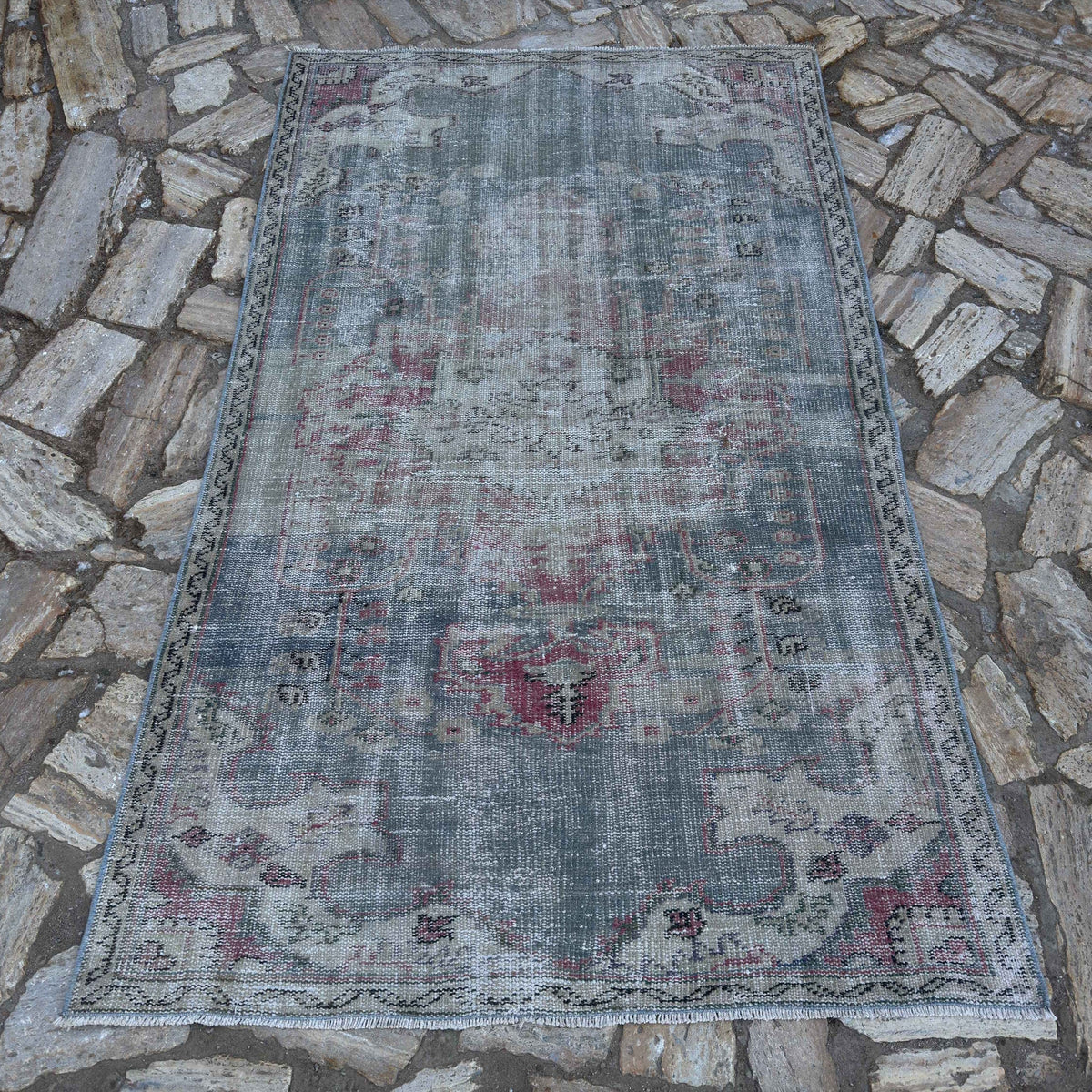Blue 4' x 7' vintage Turkish distressed rug in wool and cotton, shown on the floor.