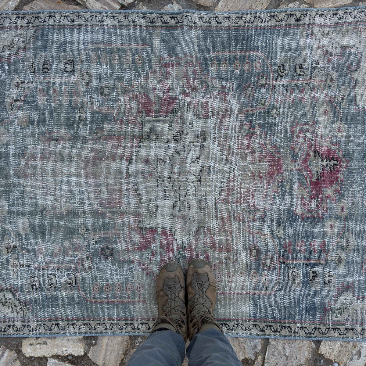 1970s blue vintage Turkish distressed rug with medallion design, hand-knotted weave and low pile.