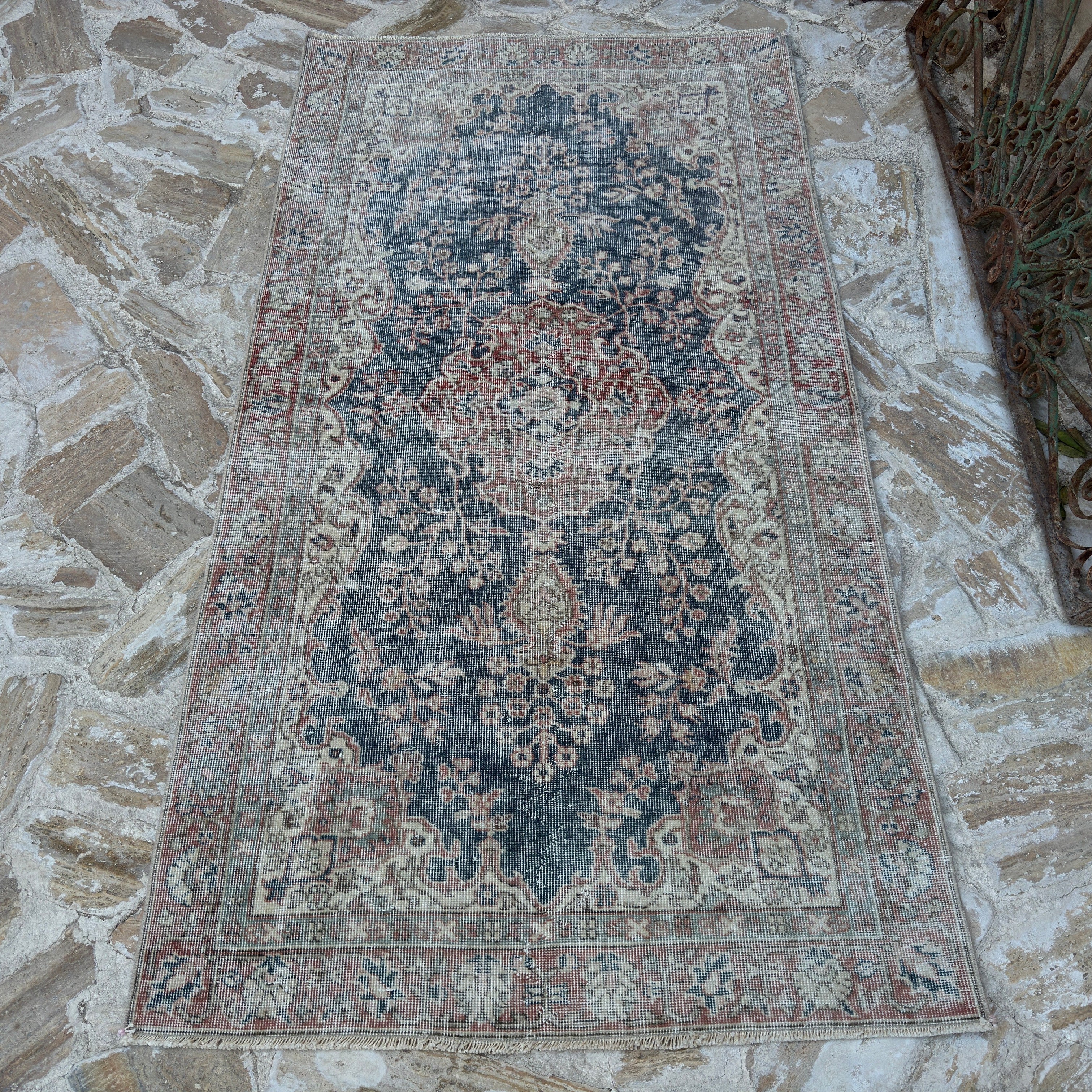 Blue 4' x 7' vintage Turkish distressed rug in wool and cotton, shown on the floor.