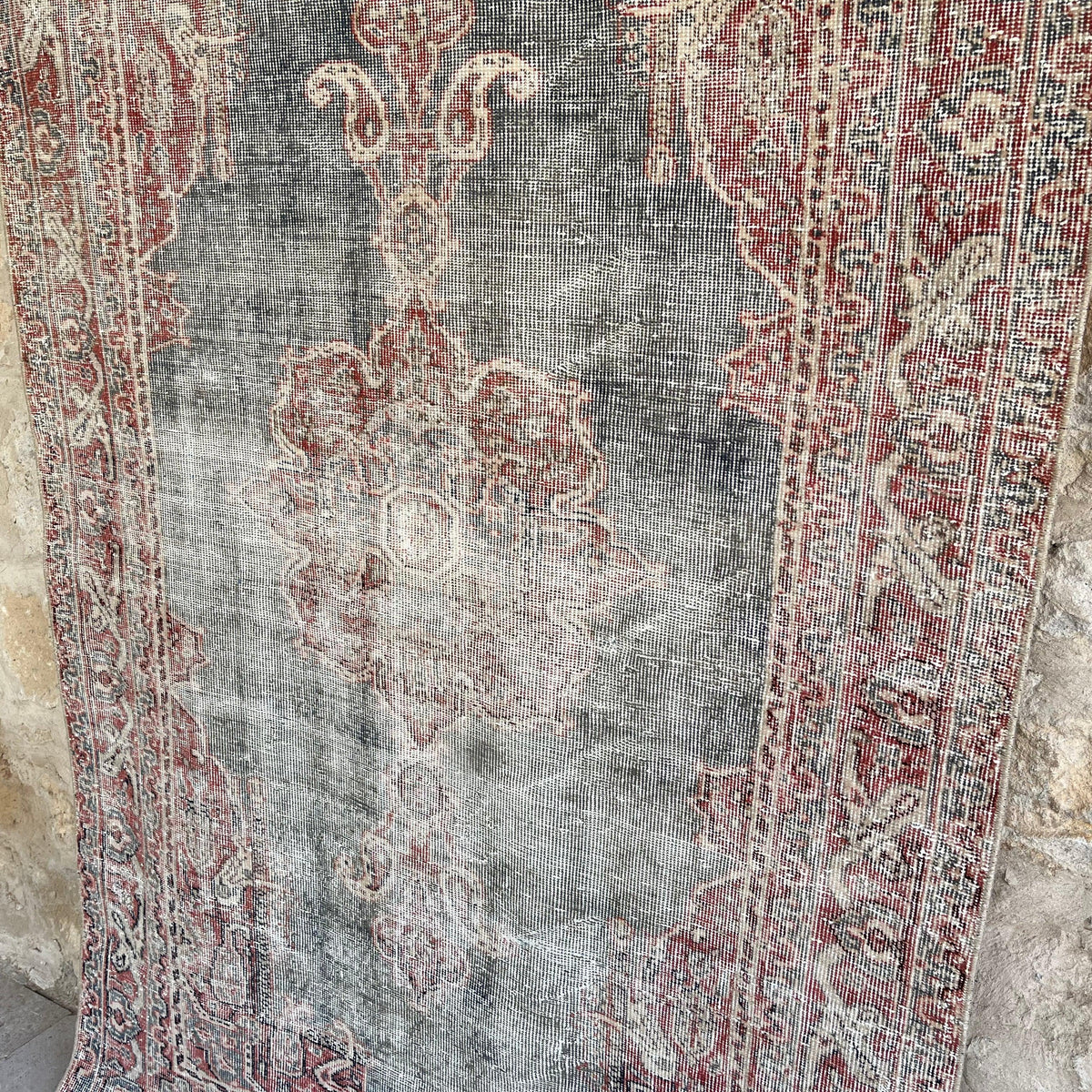 1970s blue vintage Turkish distressed rug with traditional design, hand-knotted weave and low pile.