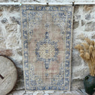 Blue 4' x 7' vintage distressed rug with geometric design, handmade in Turkey – Zach.
