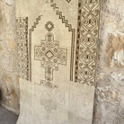 1970s brown vintage Turkish distressed rug with neutral design, hand-knotted weave and low pile.