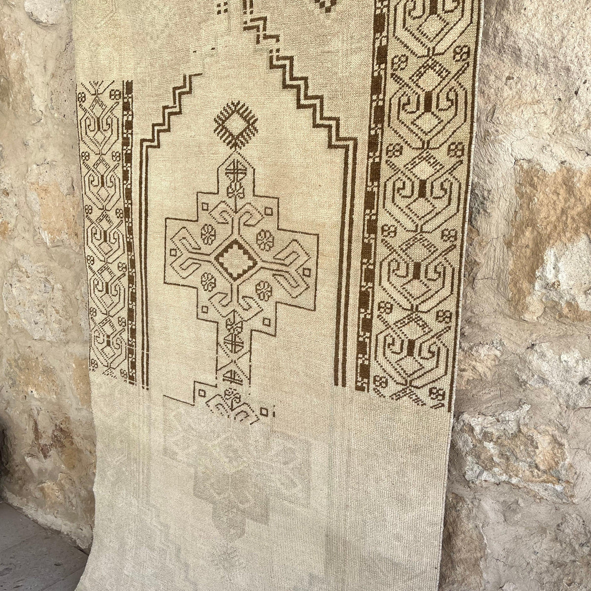 1970s brown vintage Turkish distressed rug with neutral design, hand-knotted weave and low pile.