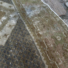 Close-up of the brown vintage Turkish distressed rug showing traditional details, hand-knotted weave, wool and cotton and low pile.
