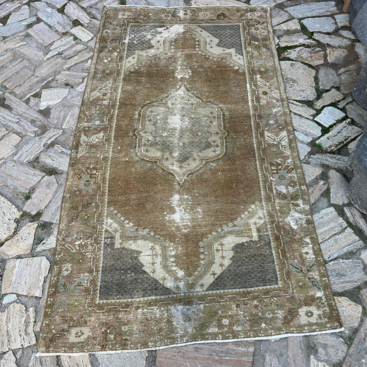 Brown 4' x 7' vintage Turkish distressed rug in wool and cotton, shown on the floor.