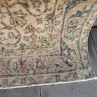 1970s pink vintage Turkish distressed rug with traditional design, hand-knotted weave and low pile.
