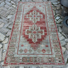 Red 4' x 7' vintage Turkish distressed rug in wool and cotton, shown on the floor.