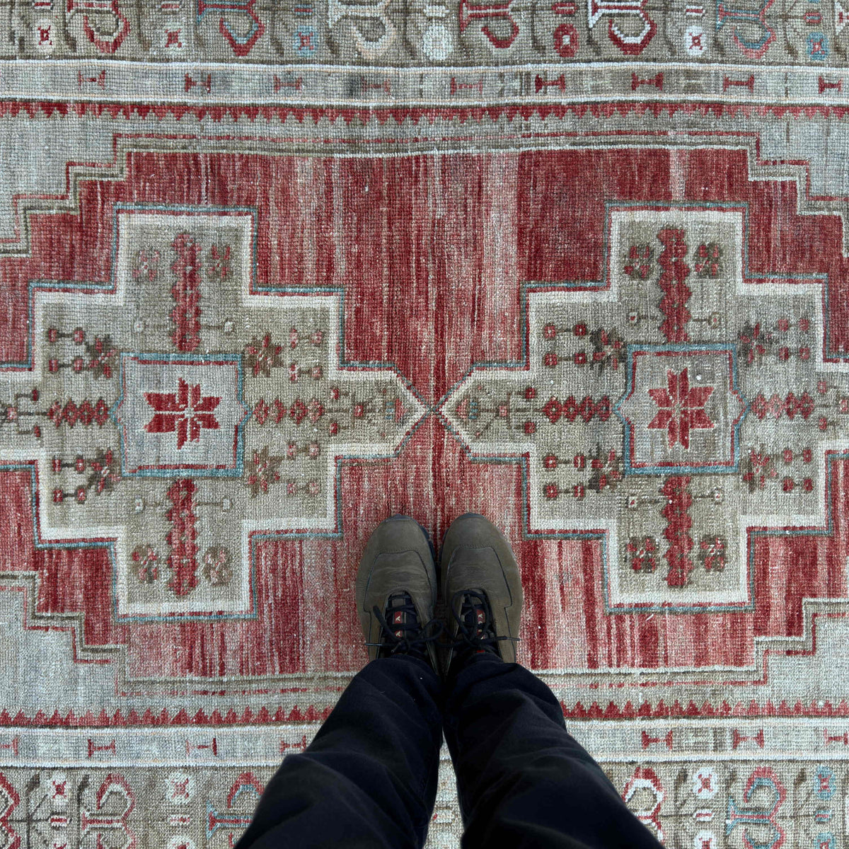 1970s red vintage Turkish distressed rug with traditional design, hand-knotted weave and low pile.