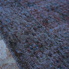 Red 4' x 7' vintage distressed rug in wool and cotton, shown on the floor.