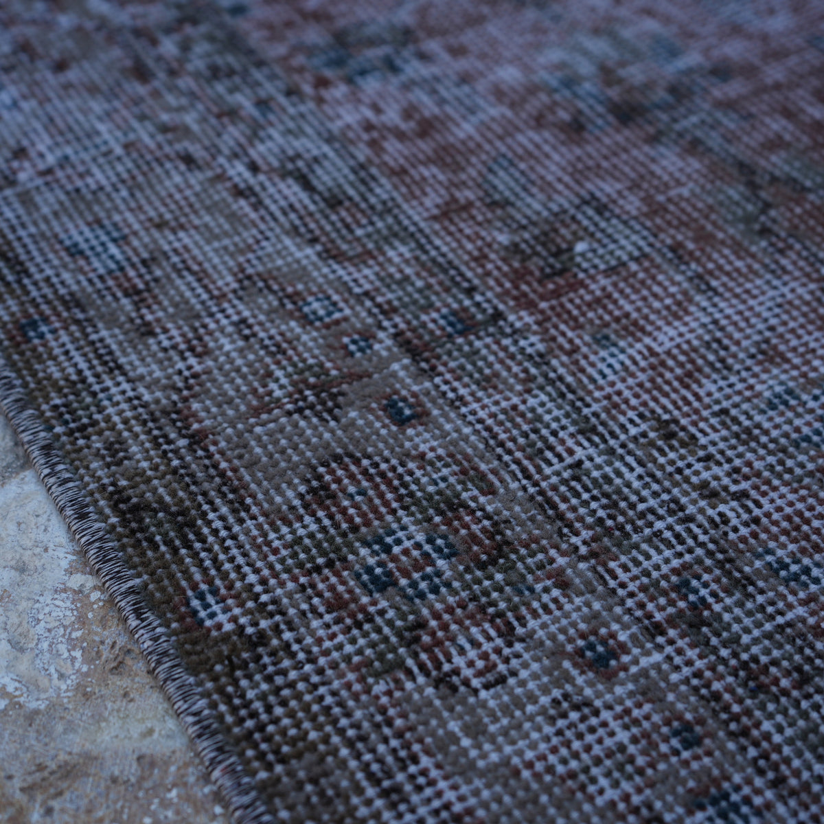 Red 4' x 7' vintage distressed rug in wool and cotton, shown on the floor.