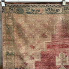 Red 4' x 7' vintage Turkish distressed rug in wool and cotton, shown on the floor.