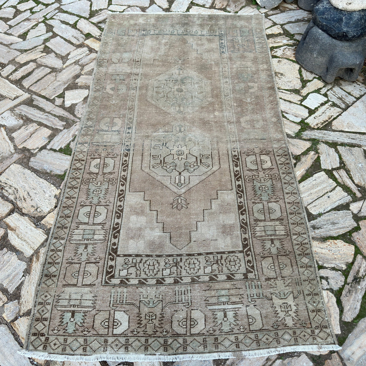 Beige 4' x 8' vintage Turkish distressed rug in wool and cotton, shown on the floor.