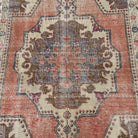 1970s orange vintage Turkish distressed rug with traditional design, hand-knotted weave and low pile.