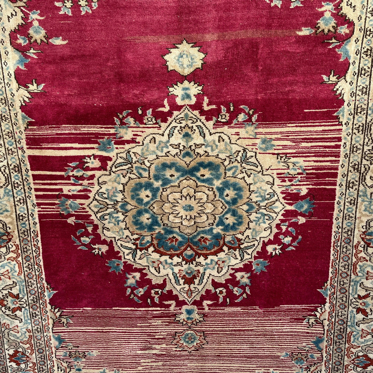 Red 5' x 7' vintage Turkish distressed rug in wool and cotton, shown on the floor.