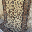 Beige 5' x 8' vintage Turkish distressed rug in wool and cotton, shown on the floor.