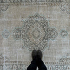 1970s beige vintage Turkish distressed rug with medallion design, hand-knotted weave and low pile.