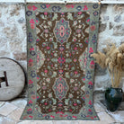 Brown 5' x 8' vintage distressed rug with geometric design, handmade in Turkey – Thatcher.