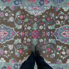 1970s brown vintage Turkish distressed rug with geometric design, hand-knotted weave and low pile.