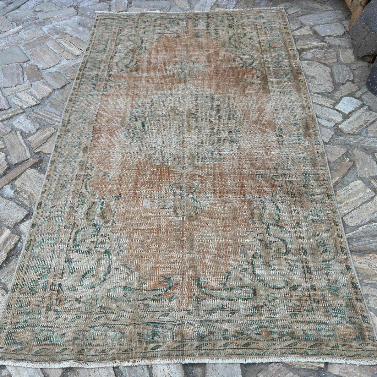 Orange 5' x 8' vintage Turkish distressed rug in wool and cotton, shown on the floor.