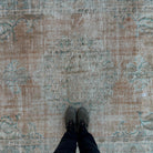 1970s orange vintage Turkish distressed rug with medallion design, hand-knotted weave and low pile.