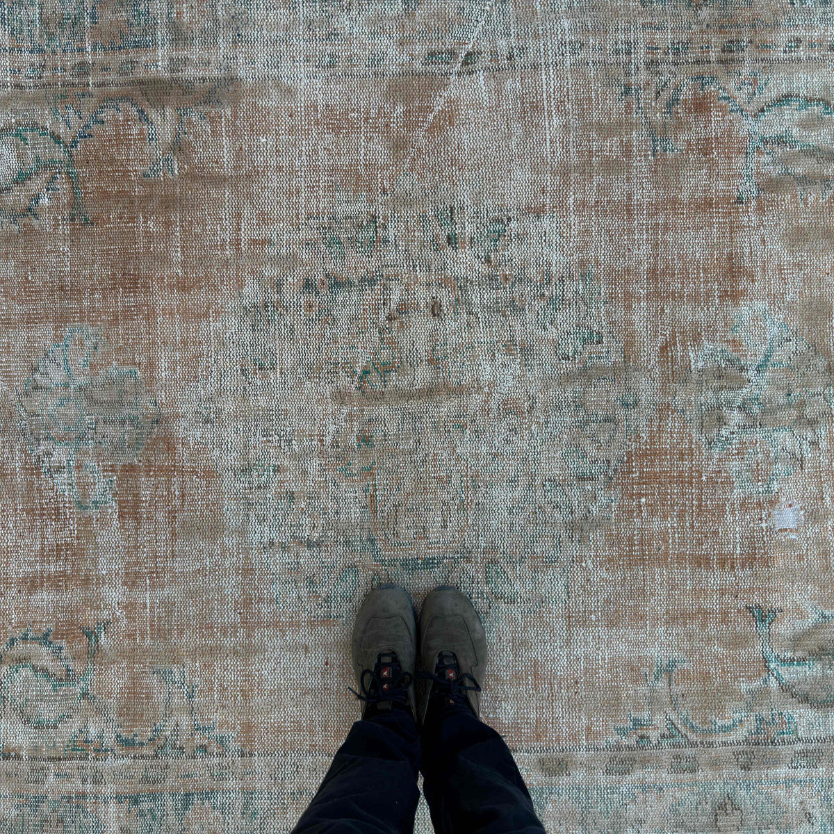 1970s orange vintage Turkish distressed rug with medallion design, hand-knotted weave and low pile.
