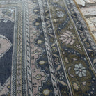 Close-up of the pink vintage Turkish distressed rug showing traditional details, hand-knotted weave, wool and cotton and low pile.