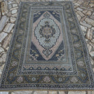 Pink 5' x 8' vintage Turkish distressed rug in wool and cotton, shown on the floor.