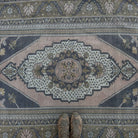 1970s pink vintage Turkish distressed rug with traditional design, hand-knotted weave and low pile.