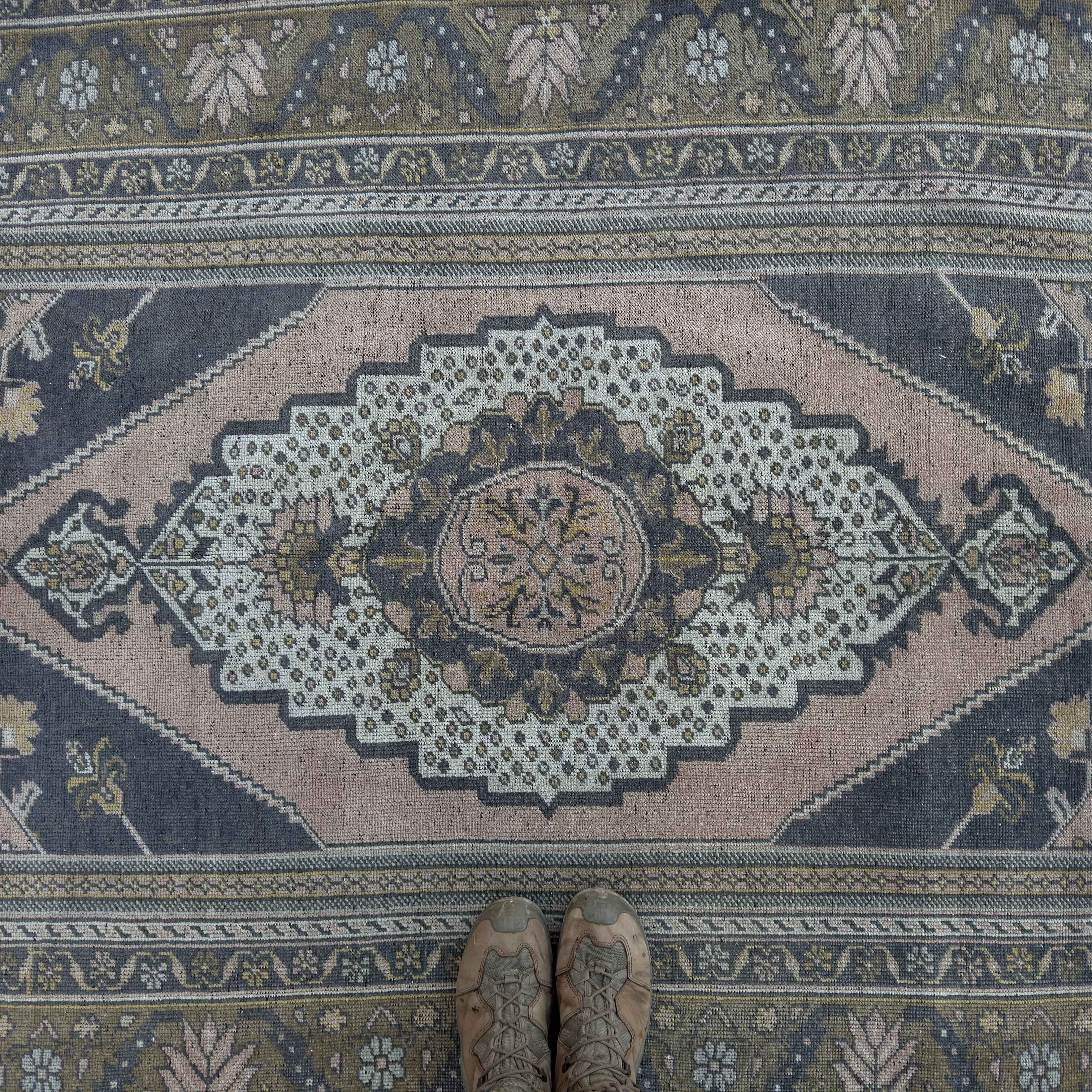 1970s pink vintage Turkish distressed rug with traditional design, hand-knotted weave and low pile.