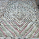 Pink 5' x 8' vintage Turkish distressed rug in wool and cotton, shown on the floor.