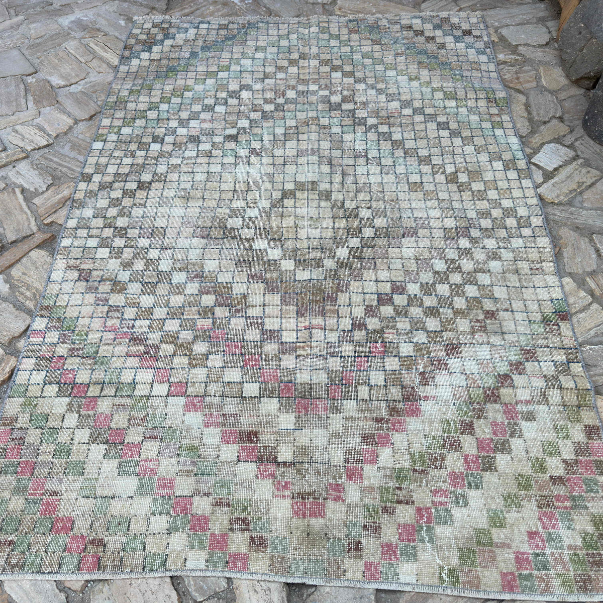 Pink 5' x 8' vintage Turkish distressed rug in wool and cotton, shown on the floor.