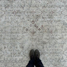 1970s beige vintage Turkish distressed rug with neutral design, hand-knotted weave and low pile.