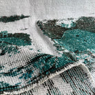 Close-up of the green vintage Turkish distressed rug showing overdyed details, hand-knotted weave, wool and cotton and low pile.