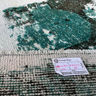 1970s green vintage Turkish distressed rug with overdyed design, hand-knotted weave and low pile.