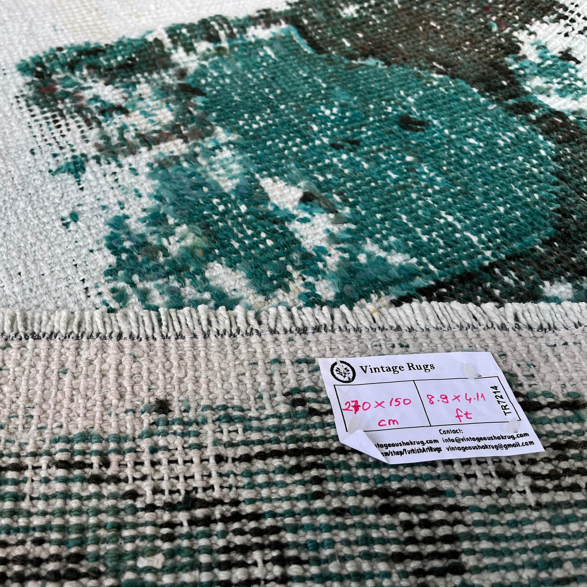 1970s green vintage Turkish distressed rug with overdyed design, hand-knotted weave and low pile.
