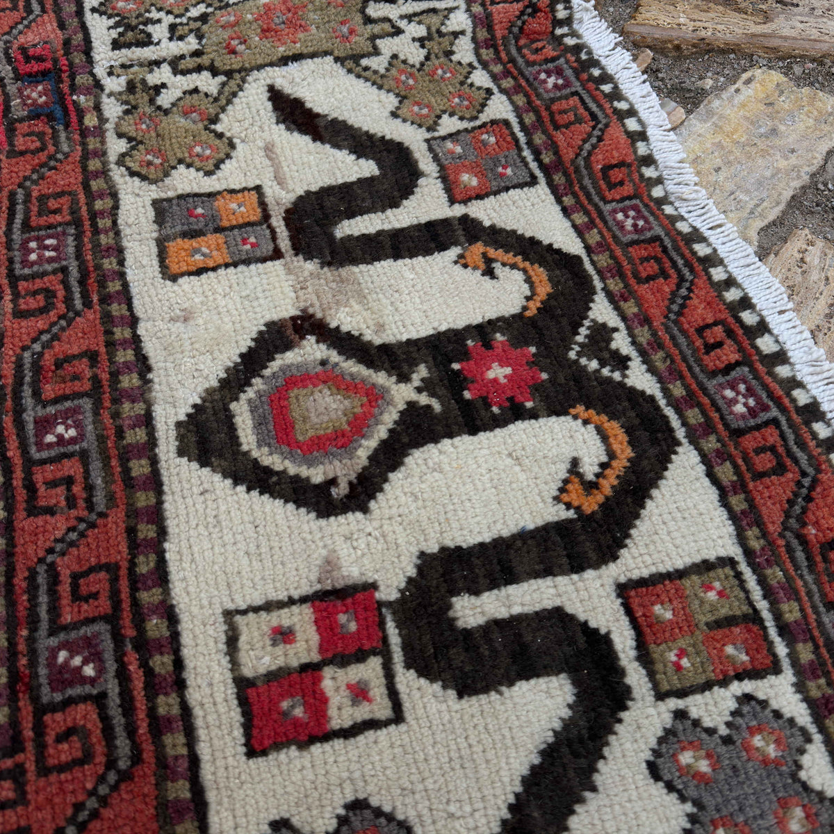 Close-up of the pale green vintage Turkish distressed rug showing traditional details, hand-knotted weave, wool and cotton and low pile.