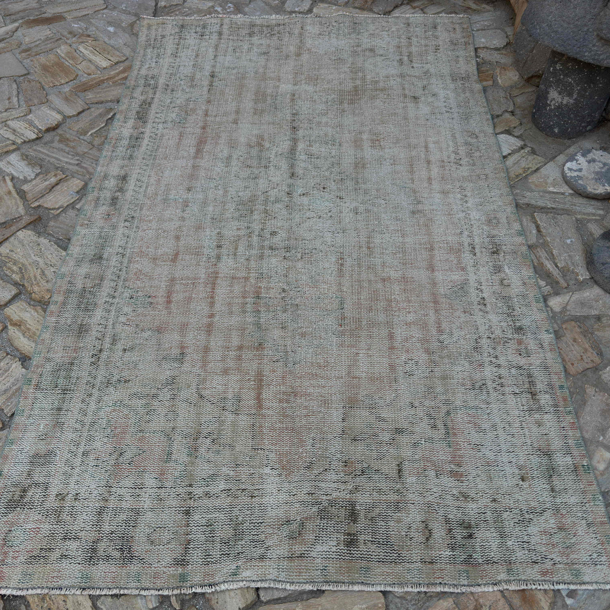 Pale Pink 5' x 9' vintage Turkish distressed rug in wool and cotton, shown on the floor.